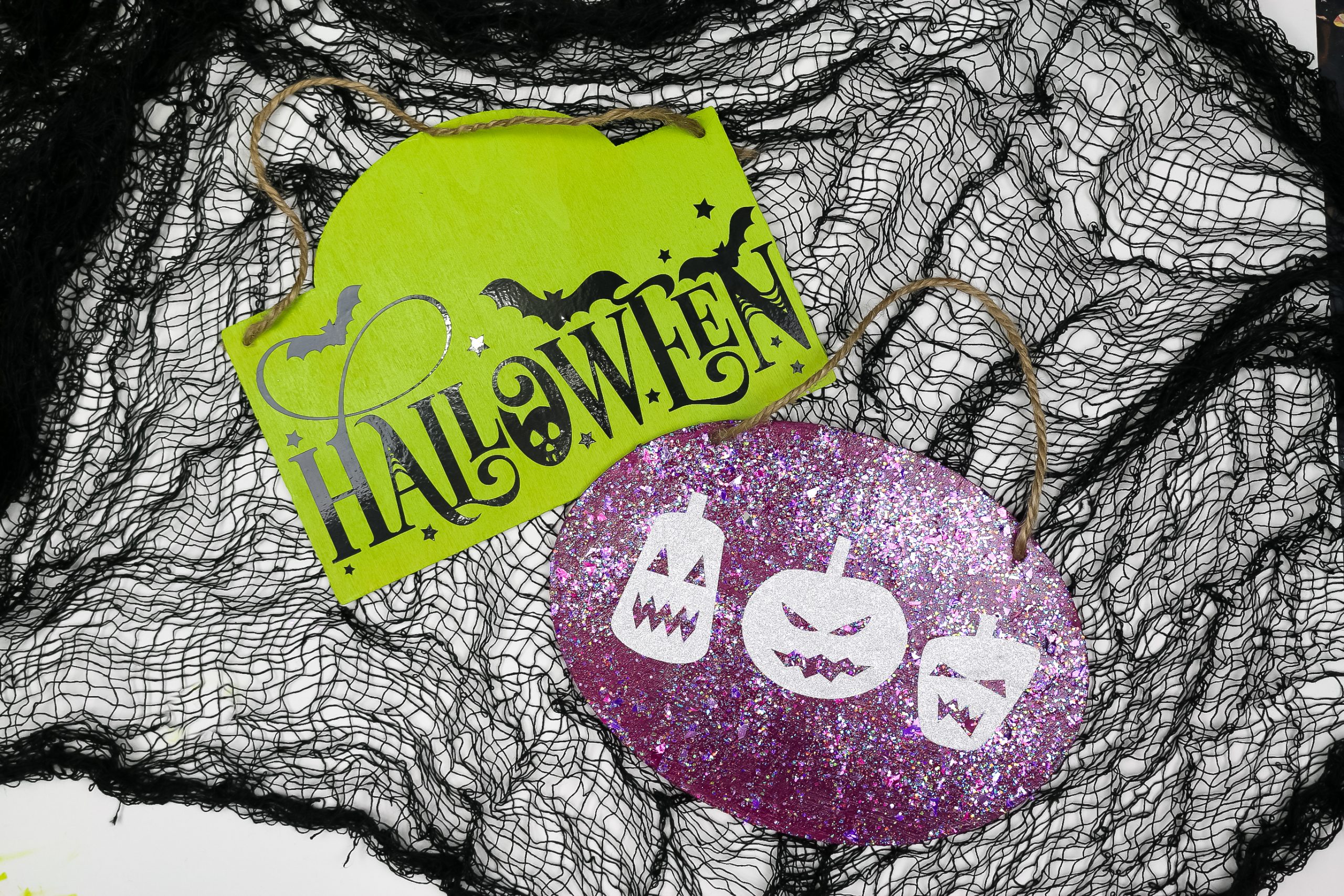 two Halloween signs made with dollar store vinyl