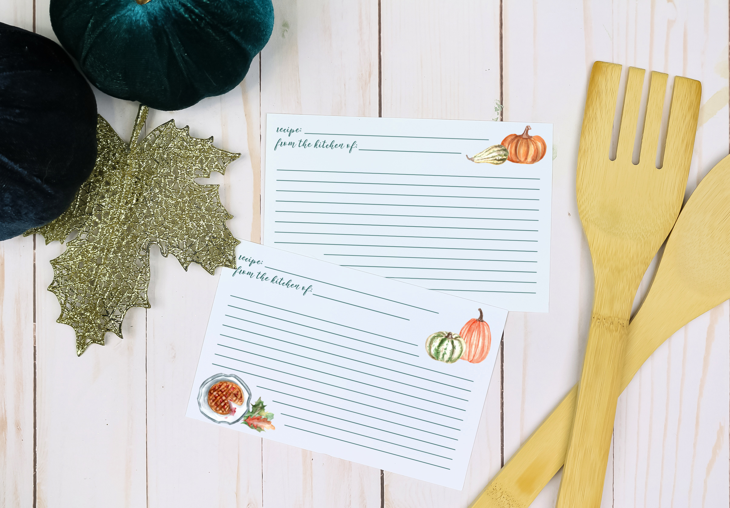 Printable Thanksgiving recipe cards next to blue pumpkins and wood serving utensils