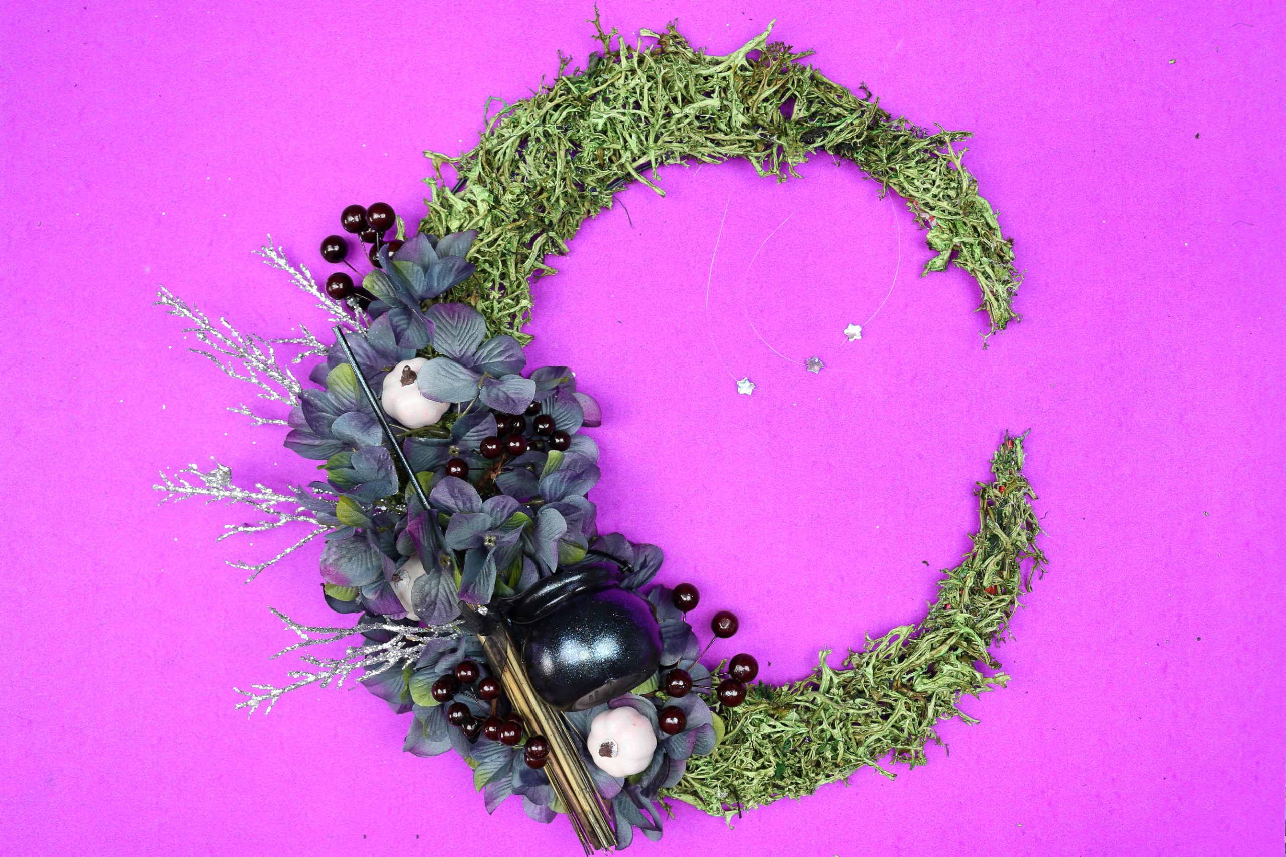 floral crescent moon wreath on a purple background