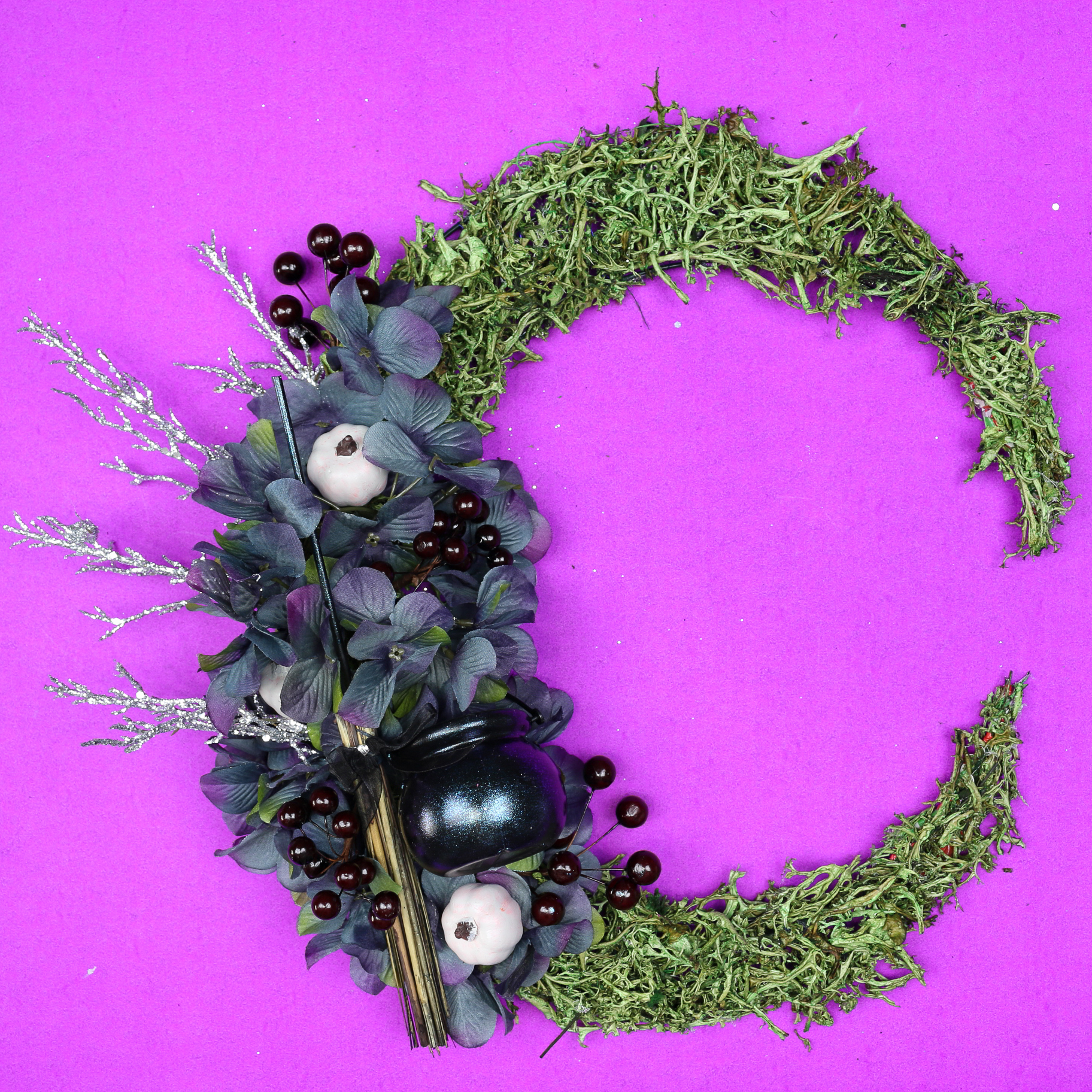 floral crescent moon wreath on a purple background