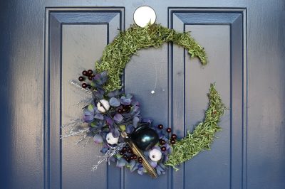 floral crescent moon wreath on a blue door