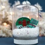 closeup of a jar ornament with snow, a vintage camper, and signs