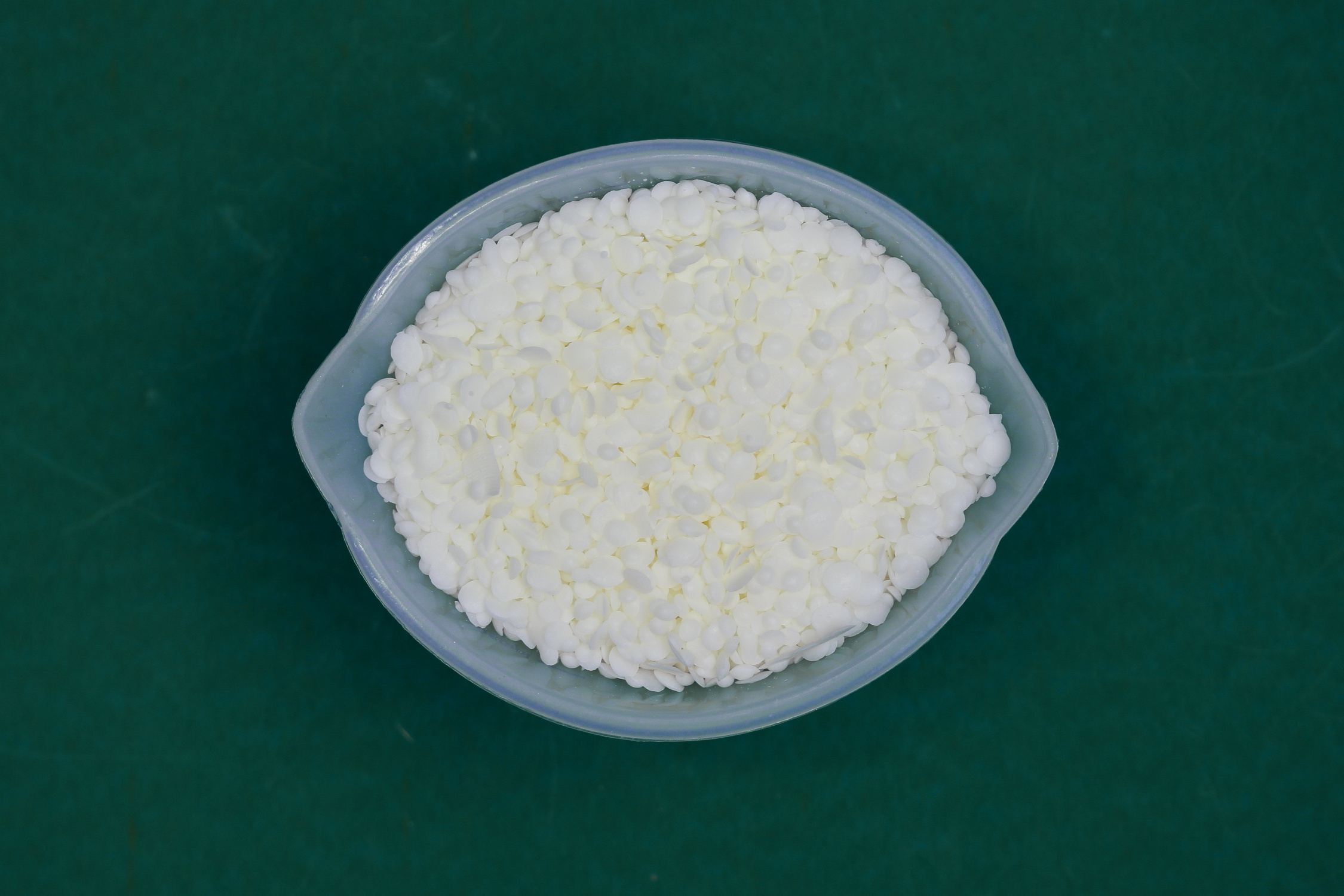 soy wax pellets in a silicone measuring cup