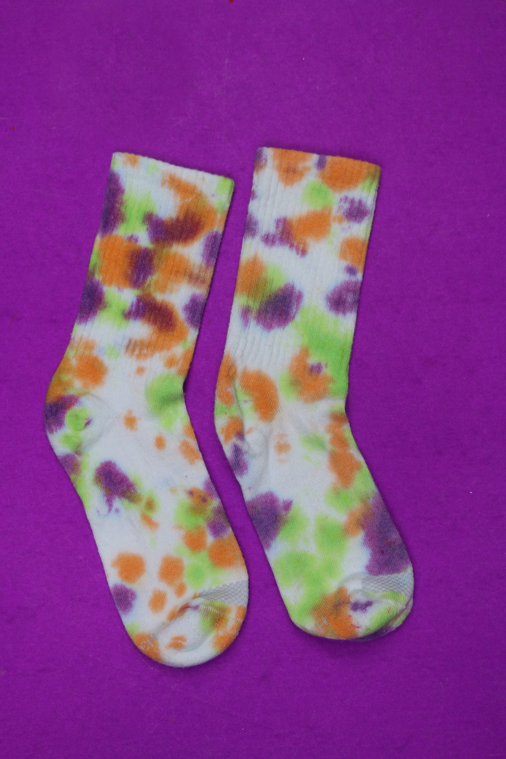 tie dyed socks on a purple background