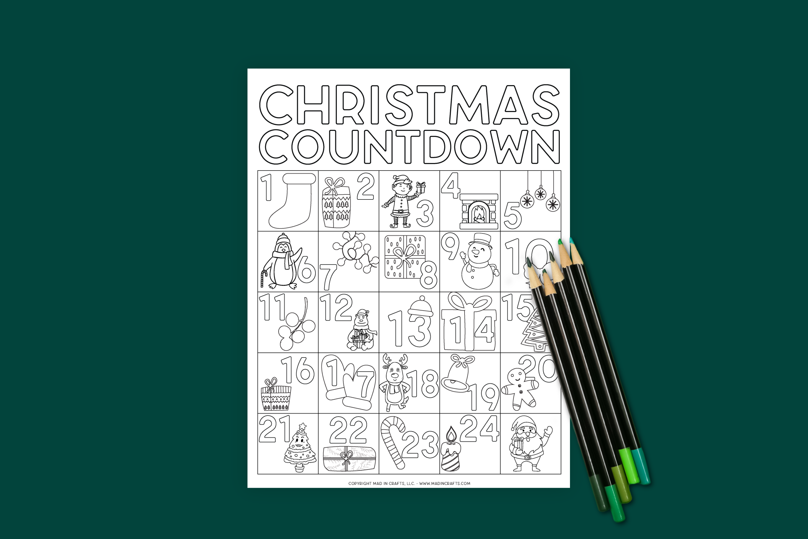 Christmas coloring countdown calendar and colored pencils on a dark green background