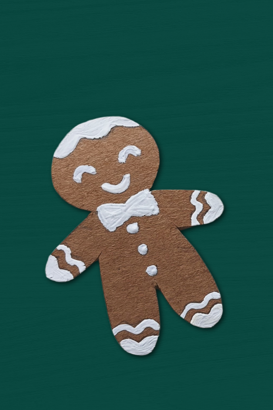 paper gingerbreadman ornament on a green background