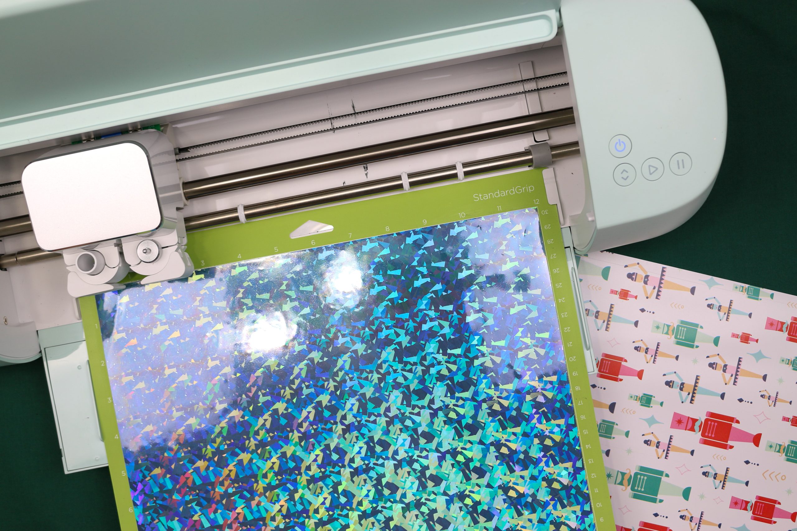 Holographic vinyl on a cutting mat loaded into a Cricut Explore 3