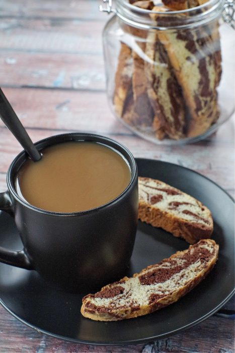 marble biscotti by a mug of coffee with a spoon