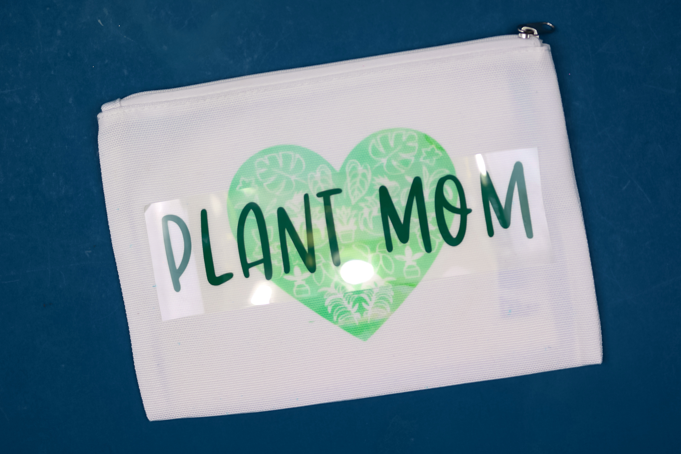 finished Plant Mom zipper pouch on a blue background