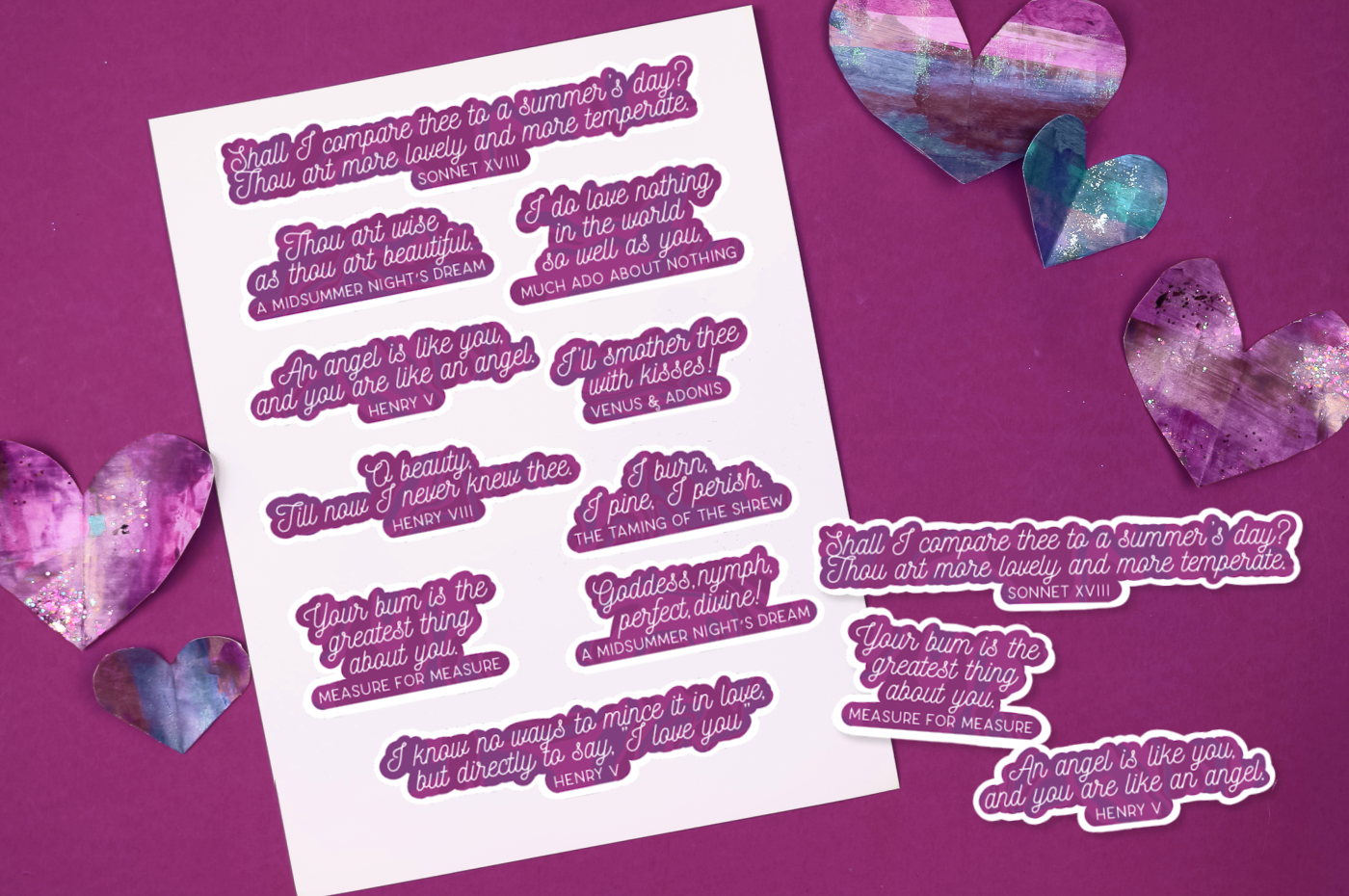 printed sheet of Shakespeare stickers near paper hearts on a purple background