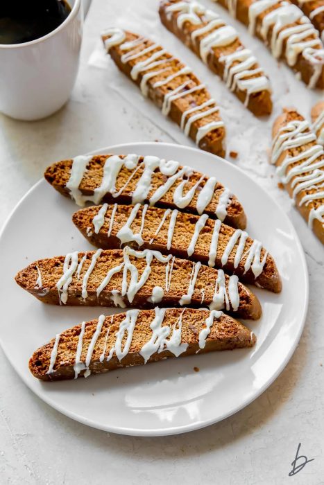 drizzled gingerbread biscotti on a white plate