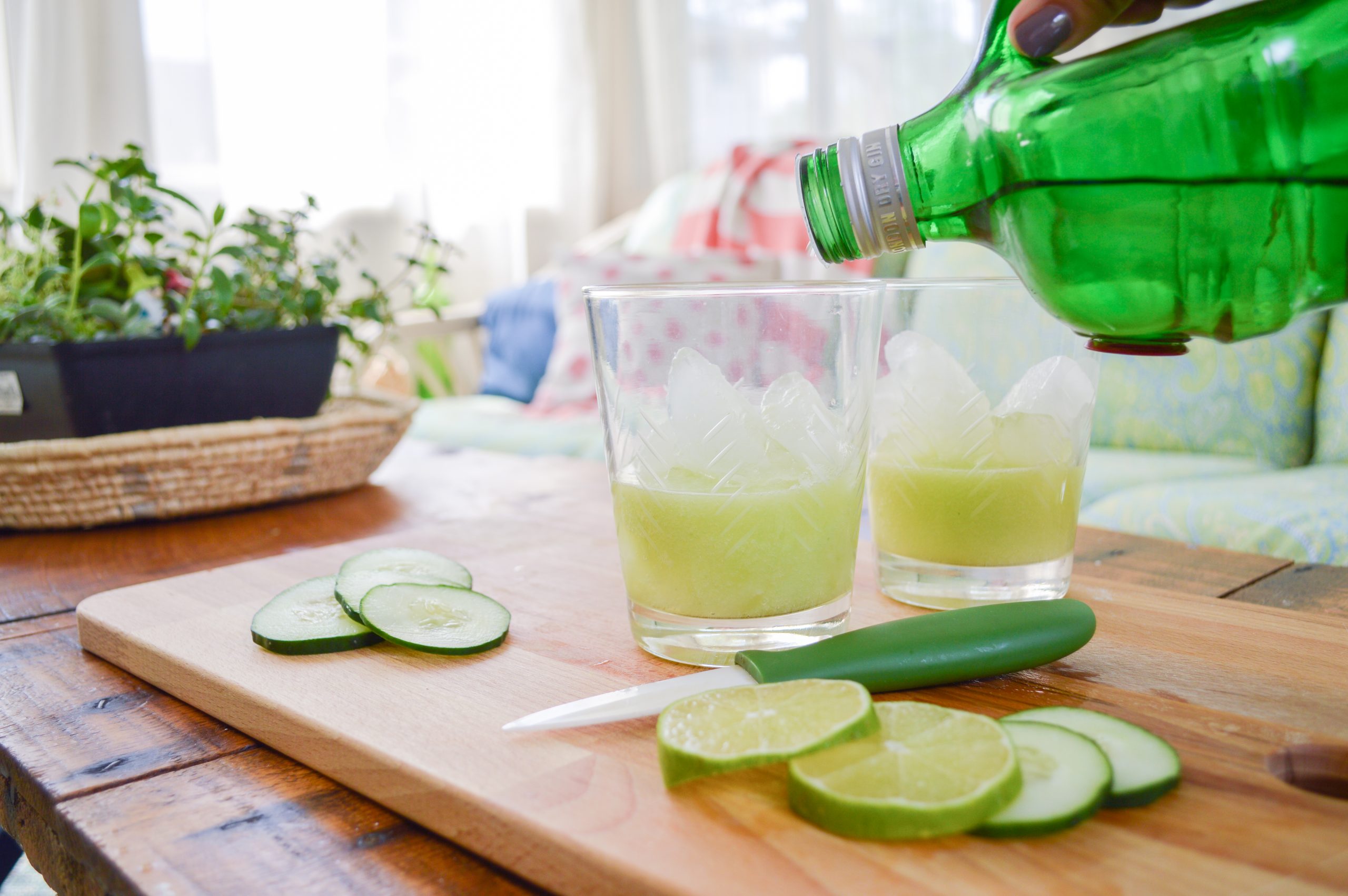 adding Tanqueray gin to cucumber lime gin and tonics