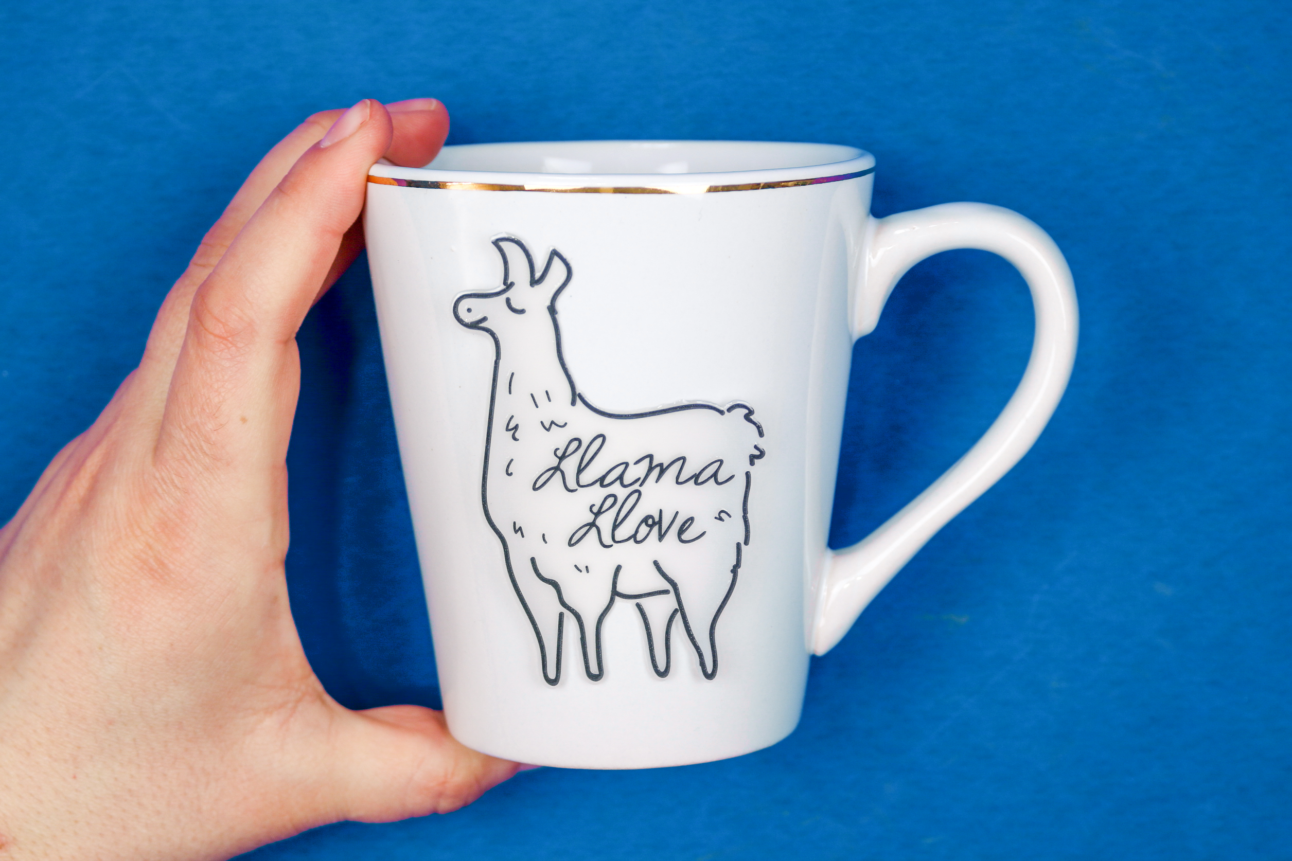 llama ceramic sticker applied to a white mug
