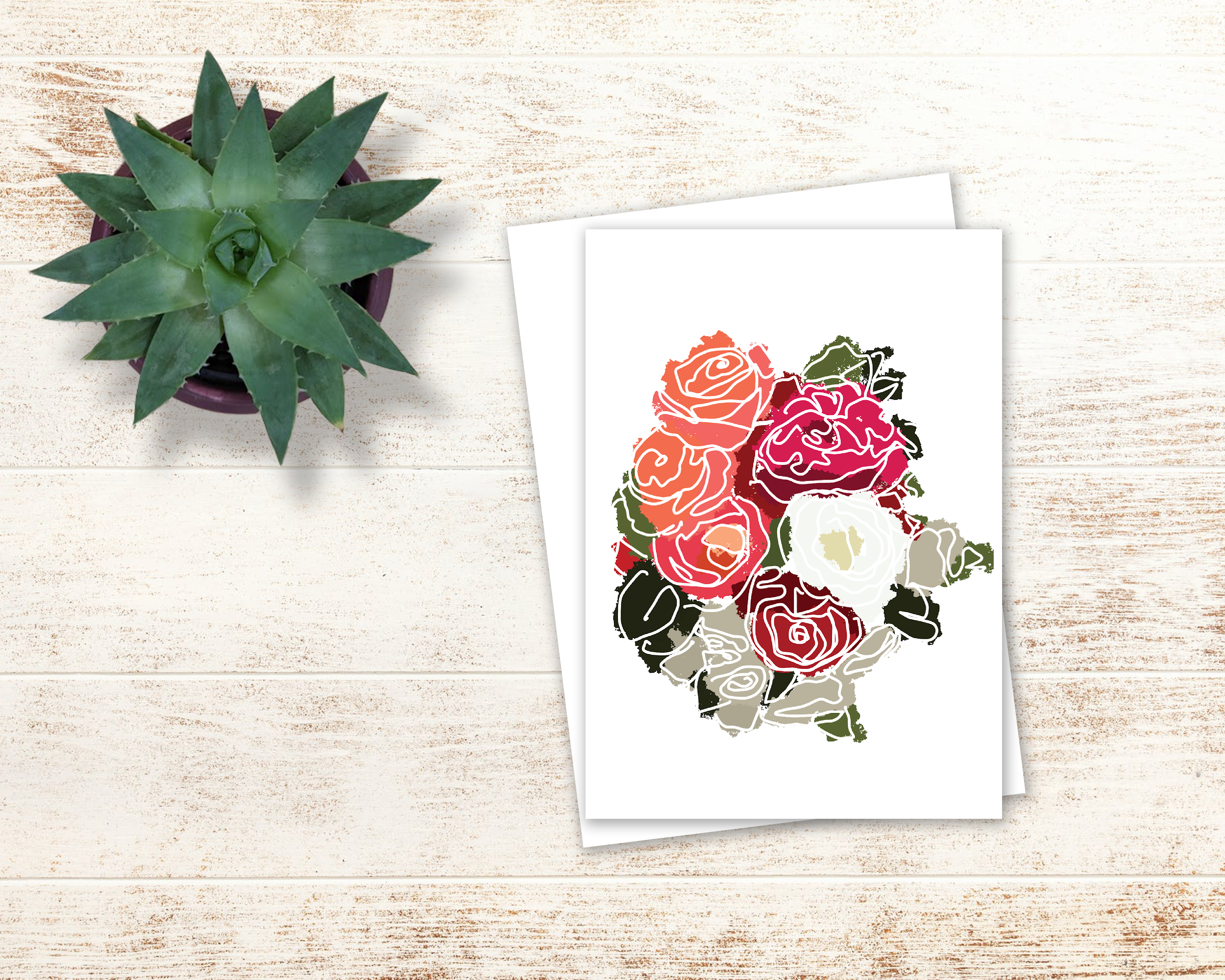 drawn floral card with white envelope by a succulent