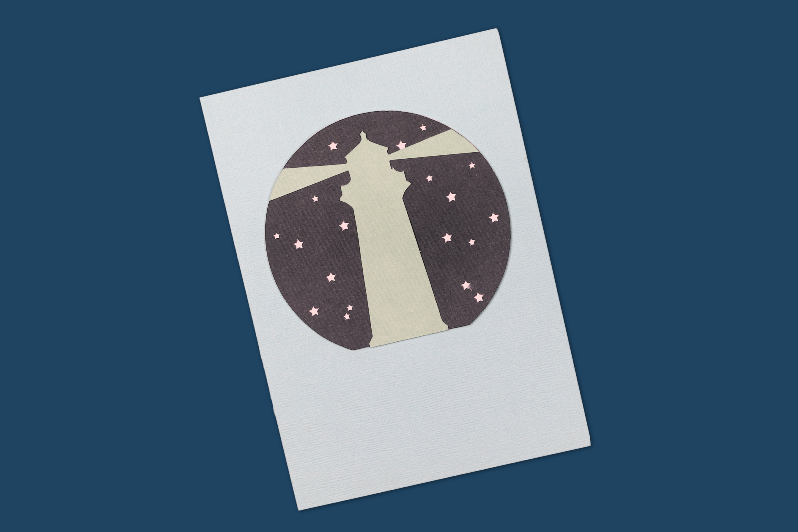 third layer of a layered lighthouse card on a blue background