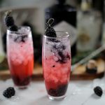 blackberry gin and tonics garnished with fresh berries