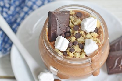 top down view of a mason jar of smores pudding on a plate with a spoon