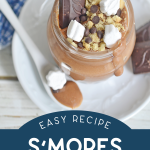 top down view of a mason jar of smores pudding on a plate with a spoon