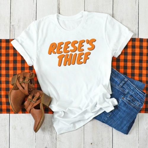 White shirt that says "Reese's Thief" on a plaid background