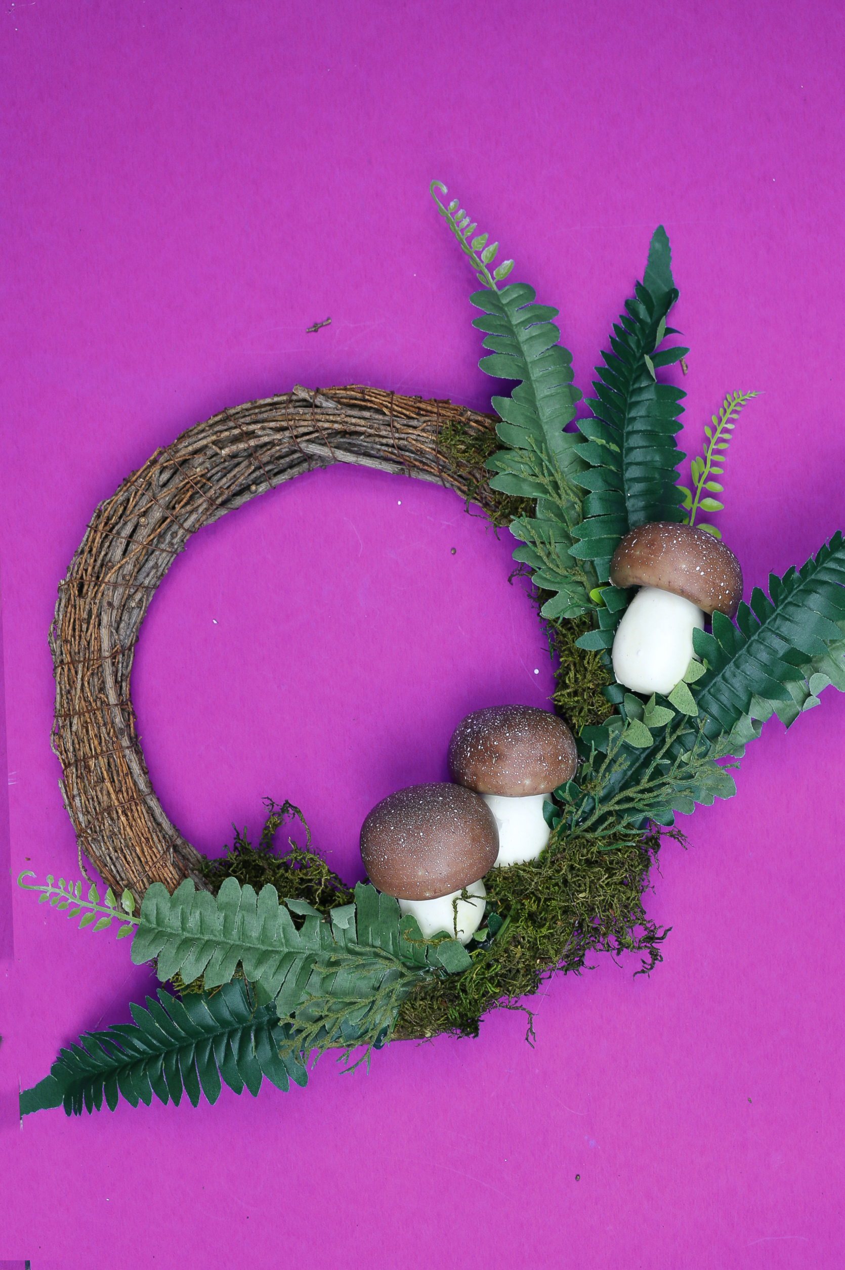 grapeview wreath decorated with faux ferns, moss, and faux mushrooms