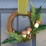 front view of a mushroom wreath hanging on a blue door