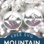 two ceramic circle ornaments decorated with glittery vinyl mountain scenes hanging from a flocked tree