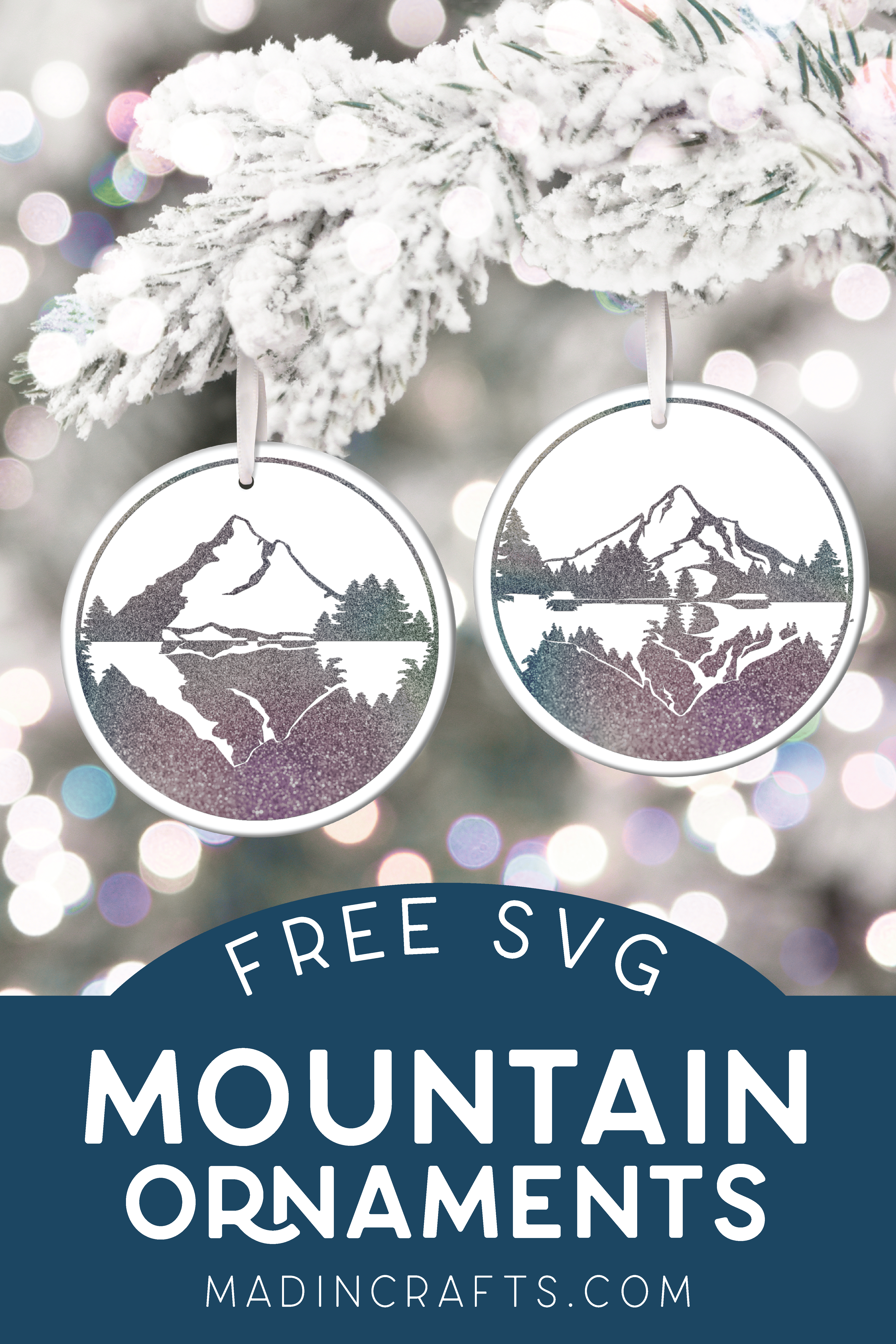 two ceramic circle ornaments decorated with glittery vinyl mountain scenes hanging from a flocked tree