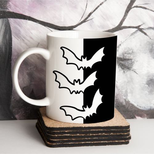 white mug with black bat decoations