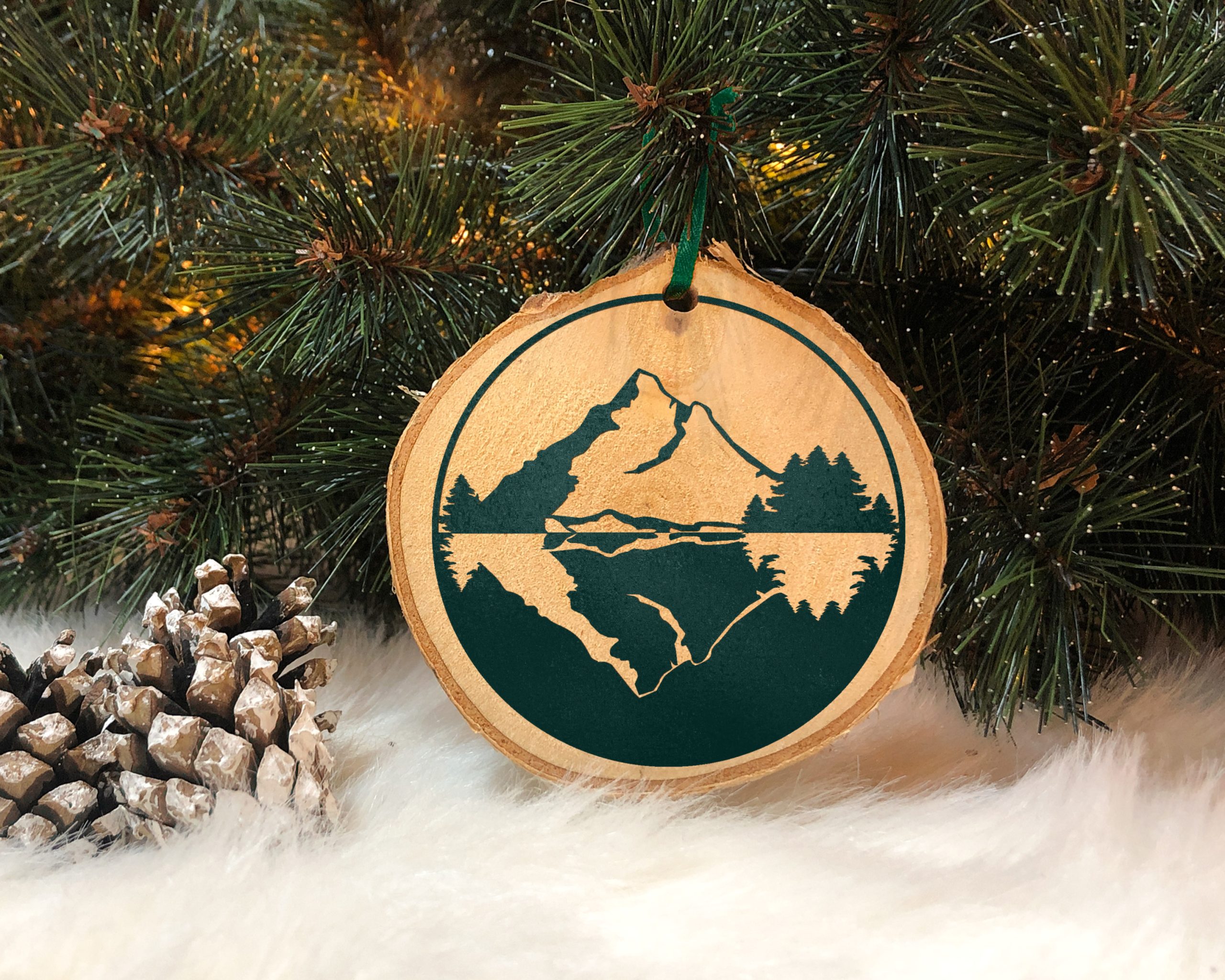 wood slice ornament decorated with foil vinyl mountains