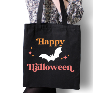 woman holding black tote bag with Happy Halloween SVG design