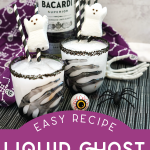 black sugar rimmed cocktail glasses filled with white cocktail and garnished with a Peeps candy ghost