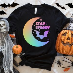 black t-shirt with colorful Stay Spooky design near halloween decoraitons