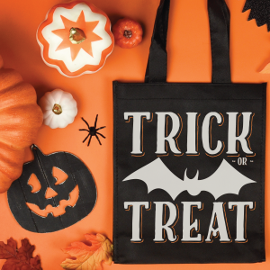 black trick or treat tote bag near halloween decorations
