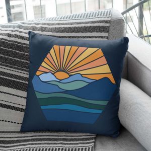 blue throw pillow with mountain design on a couch