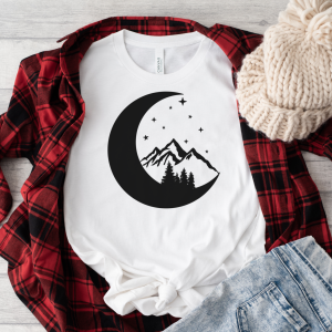 white shirt with mountain and moon design under a red and black flanner
