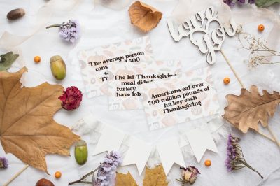 Thanksgiving trivia cards on a fall table