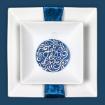 white square plate setting with glittered blue acrylic disc place card
