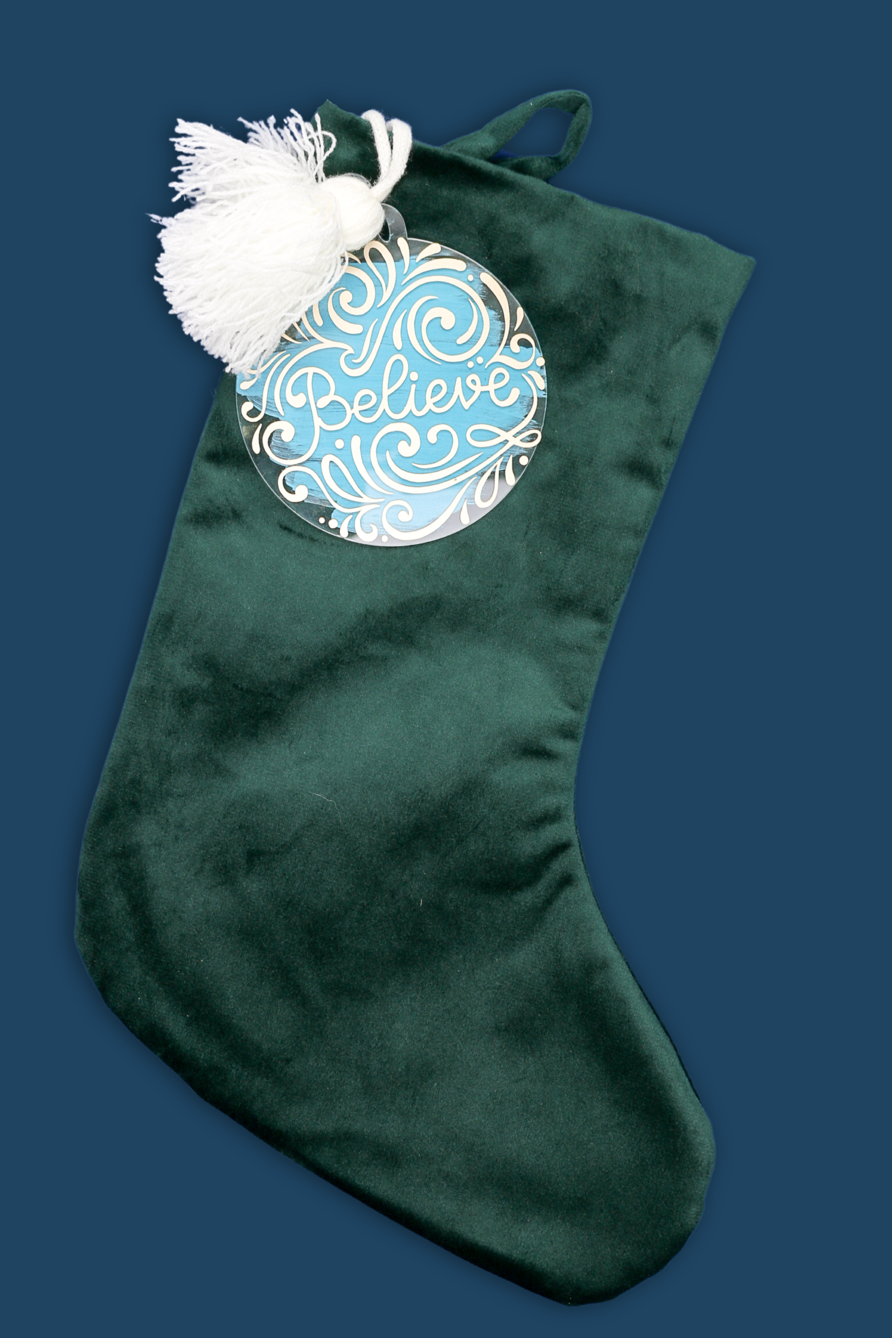 green velvet Christmas stocking with acrylic disc stocking marker