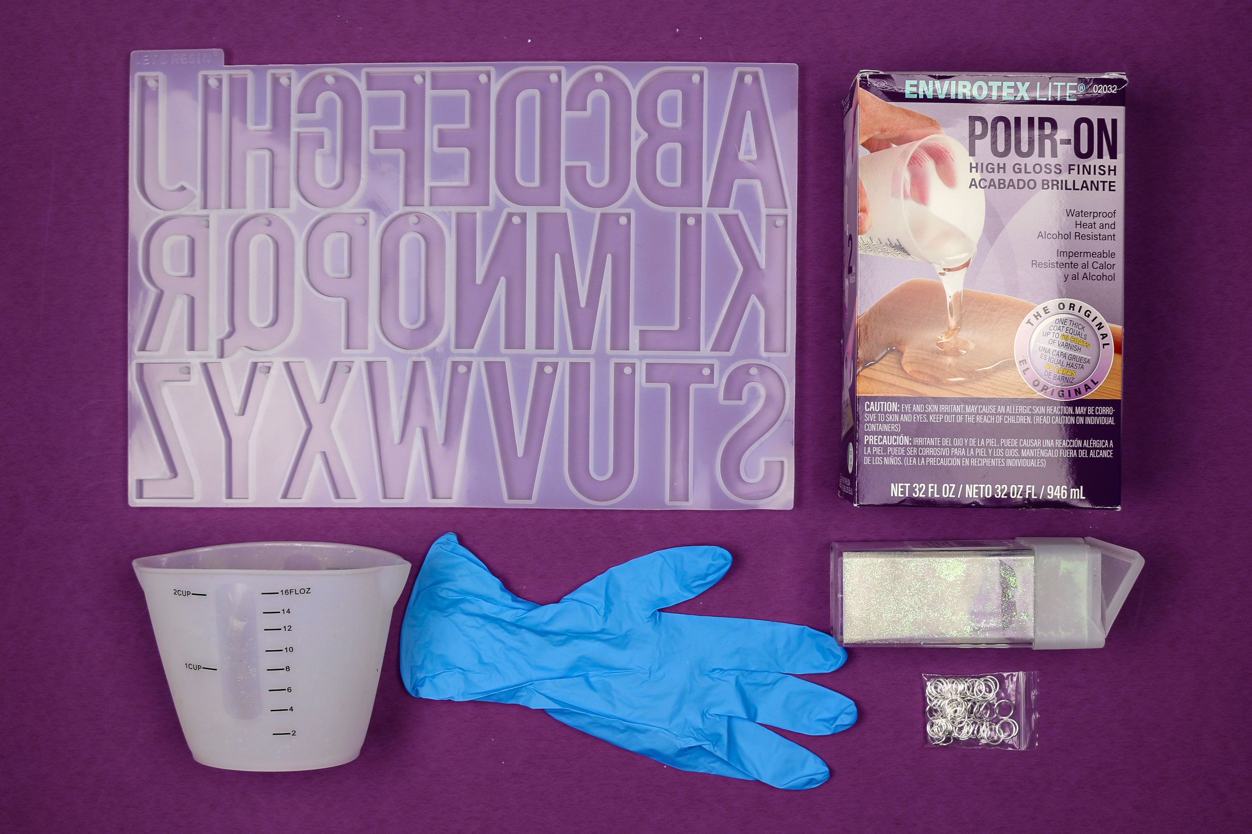 flat lay of resin craft supplies on a purple background