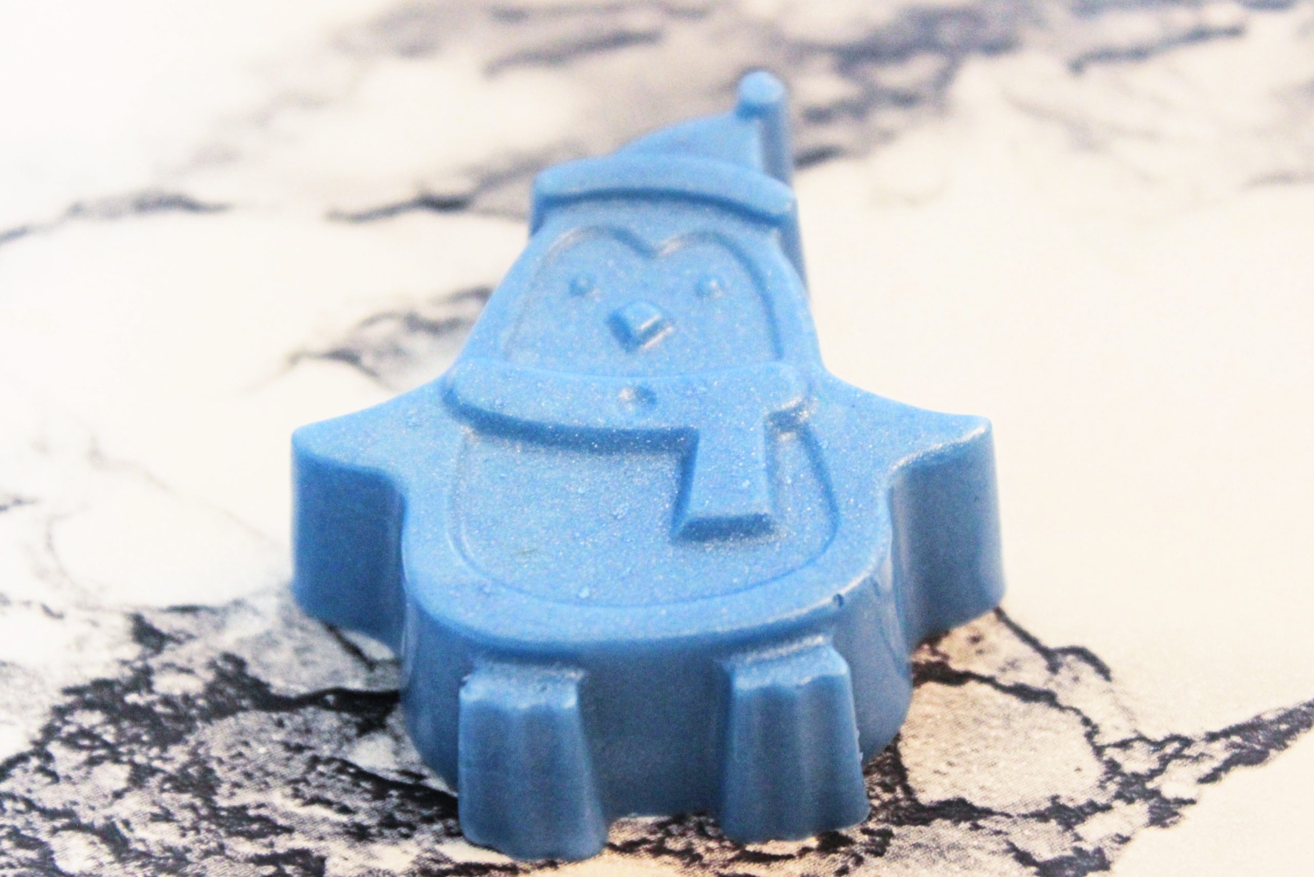 blue penguin shaped soap on a marble table