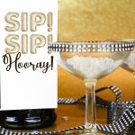 closeup Champagne bottle with Sip! Sip! Hooray! bottle tag on a gold background
