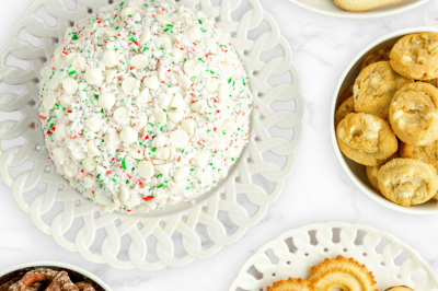 white chocolate peppermint cheesecake ball on a platter near cookies