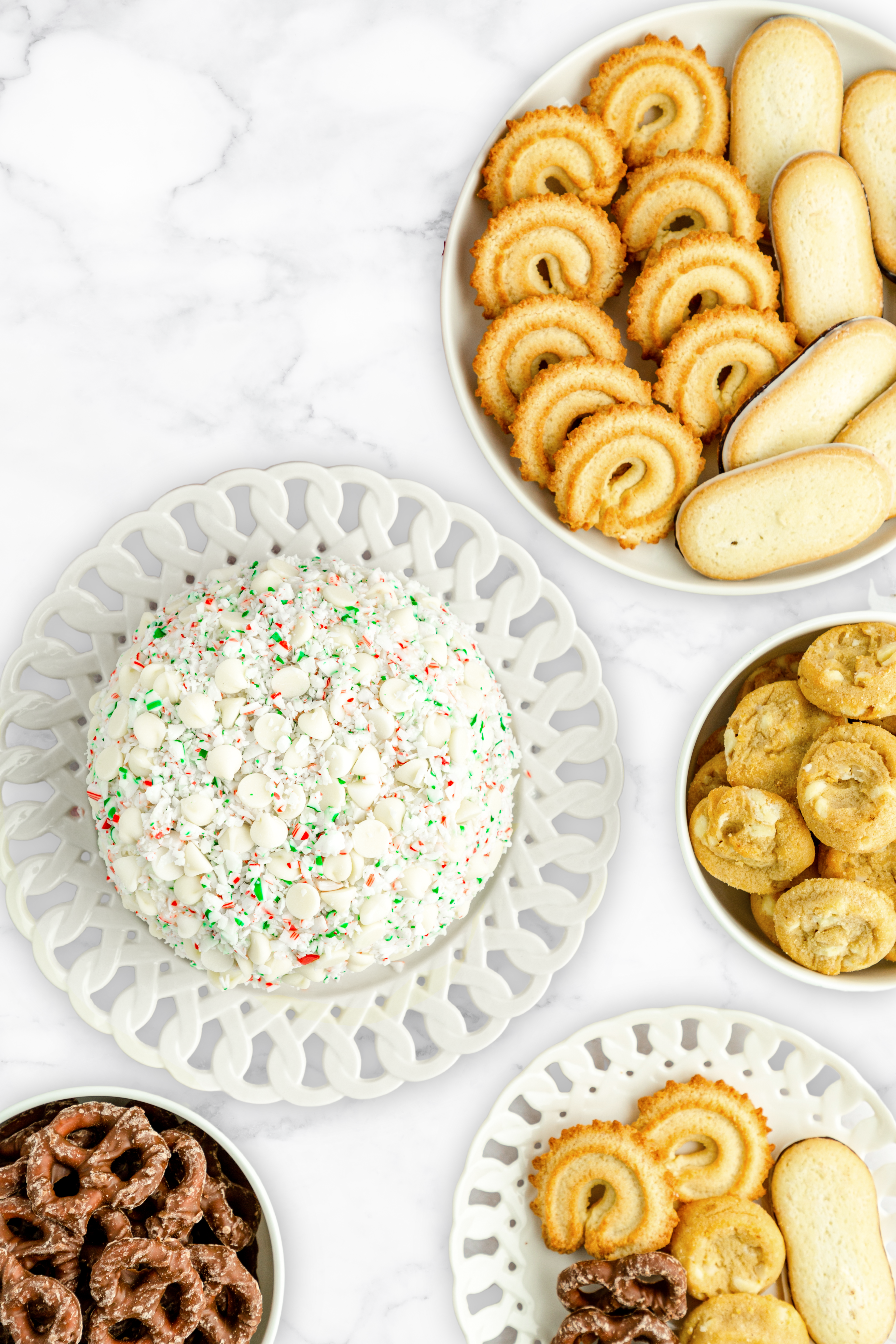 white chocolate peppermint cheesecake ball on a platter near cookies