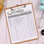 A clipboard holding an Easter dinner guest list printable with writing on it. The clipboard is near baking tools