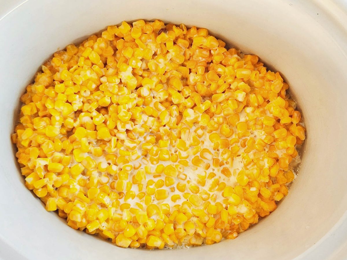 A close up of slow cooker full of street corn casserole