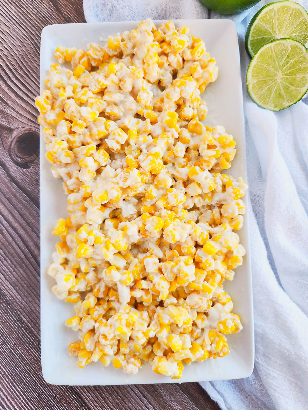 Top down view of a white serving dish of Mexican street corn