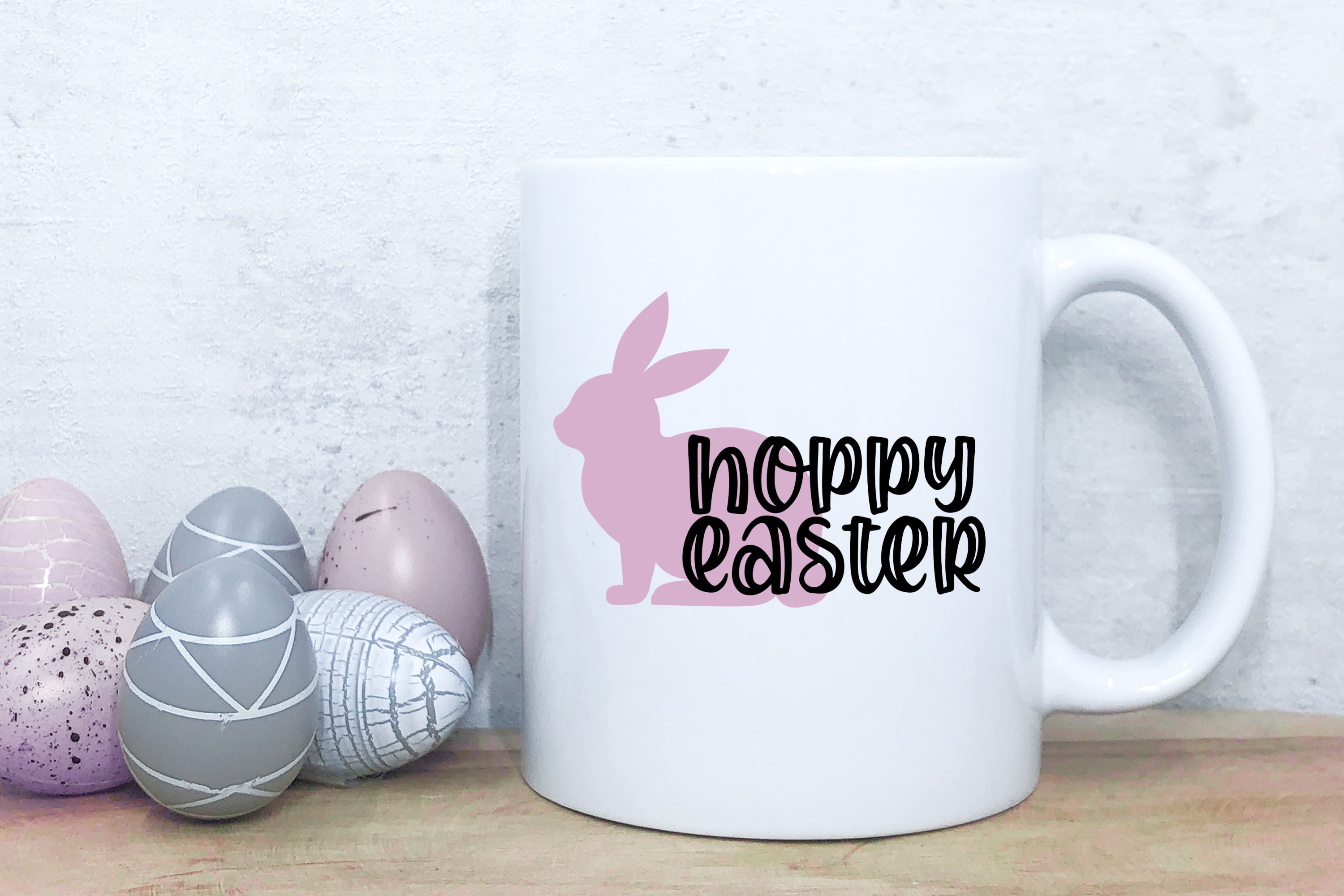 White coffee mug Easter SVG design near Easter eggs