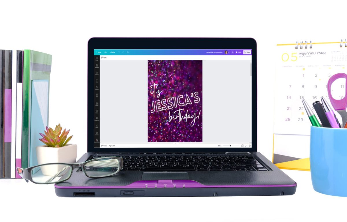 Small laptop on a desk. The laptop screen shows Canva editing the video party invitation template.