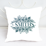 A family name SVG on a white pillow on a white framed bed.