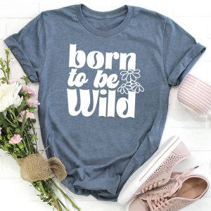Born to be Wild SVG on a blue t-shirt near flowers